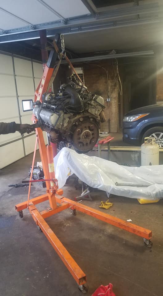 Engine being lifted with professional hoist